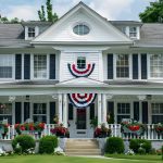 Beautiful white family home in Wisconsin with American flags and garden decorations, symbolizing secure living with reliable home insurance Wisconsin.